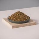 Traditional zaatar blend featuring thyme, sumac, and sesame seeds in a rustic, authentic presentation.