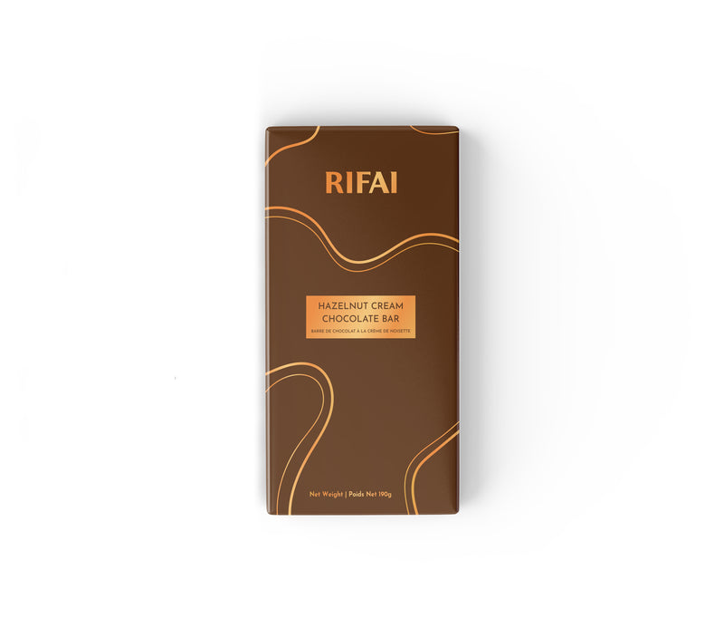 Milk chocolate bar filled with creamy hazelnut spread and whole roasted hazelnuts, shown with a smooth cut revealing the rich filling.